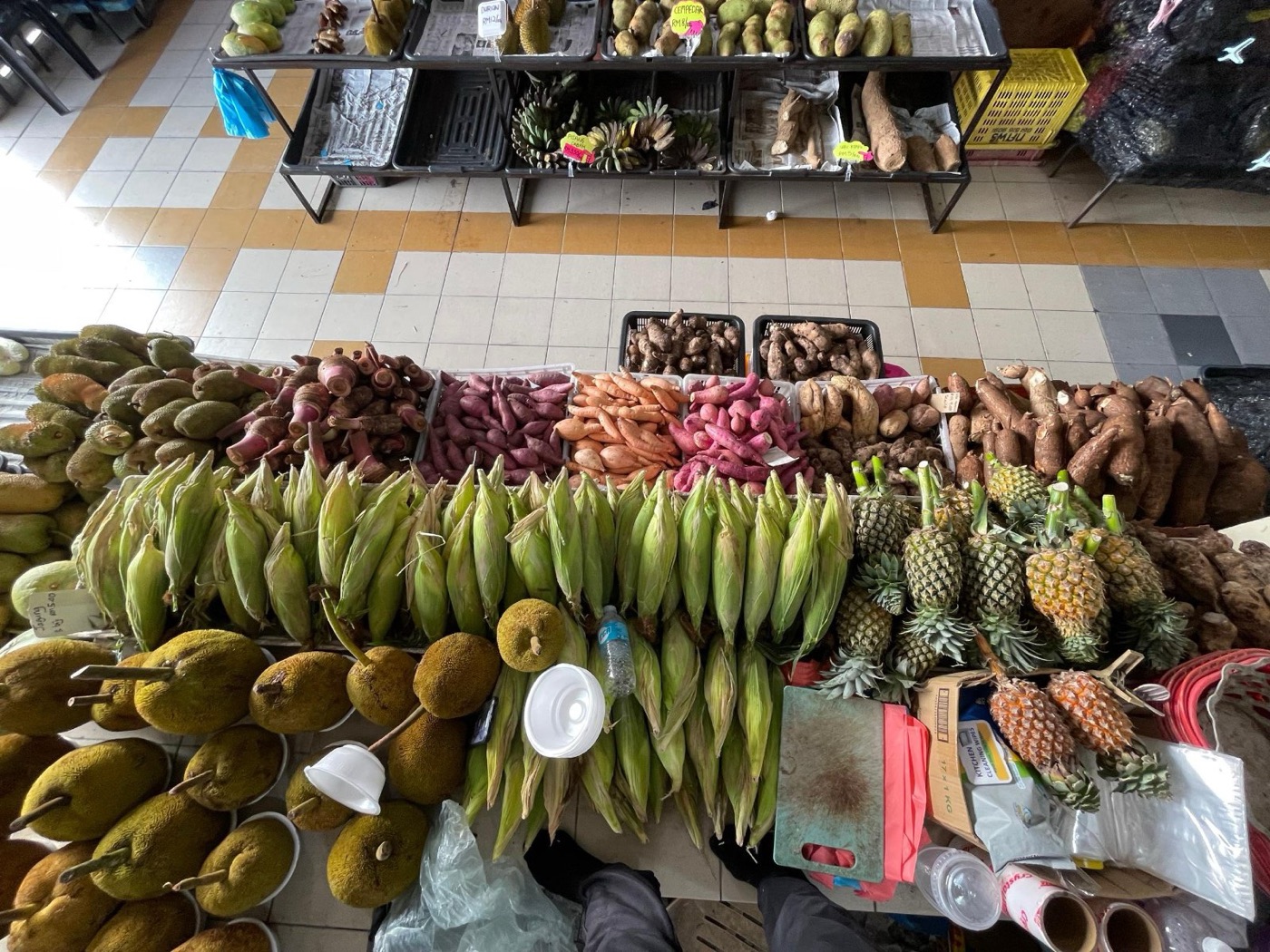 Stall D70 with corn, pineapples, sweet potatoes and tarap